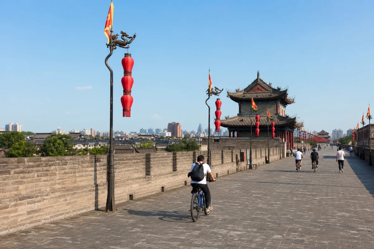 Cyclists passing a watchtower on Xi'an City Wall