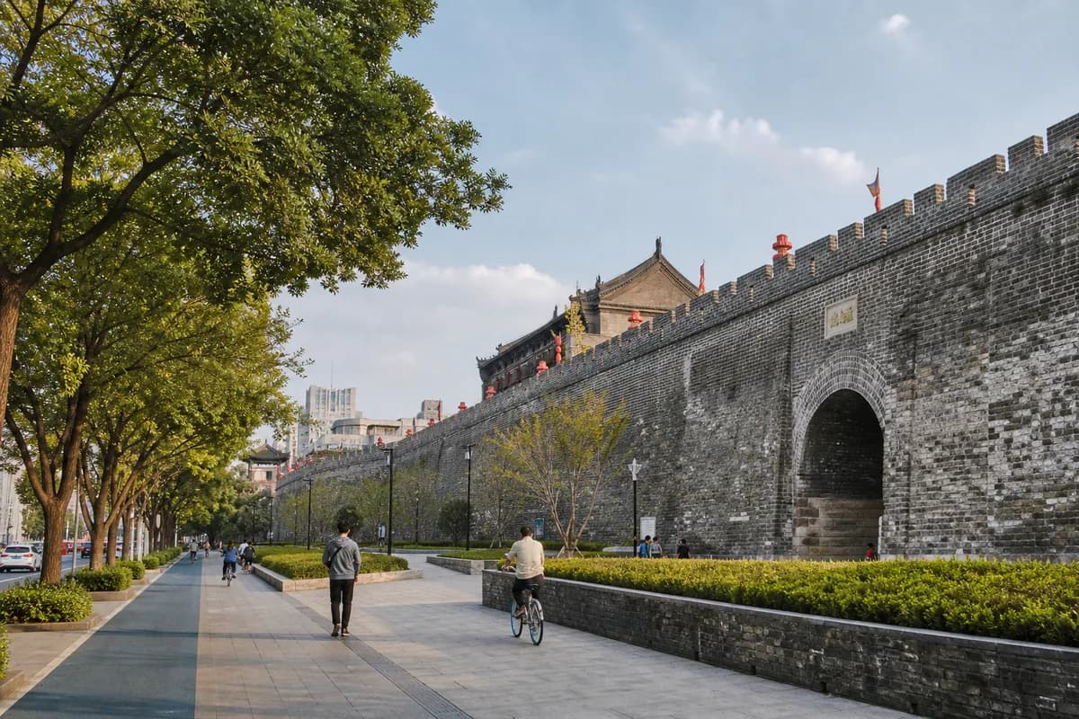 Nanjing's gray-brick city wall beside a modern pedestrian route.