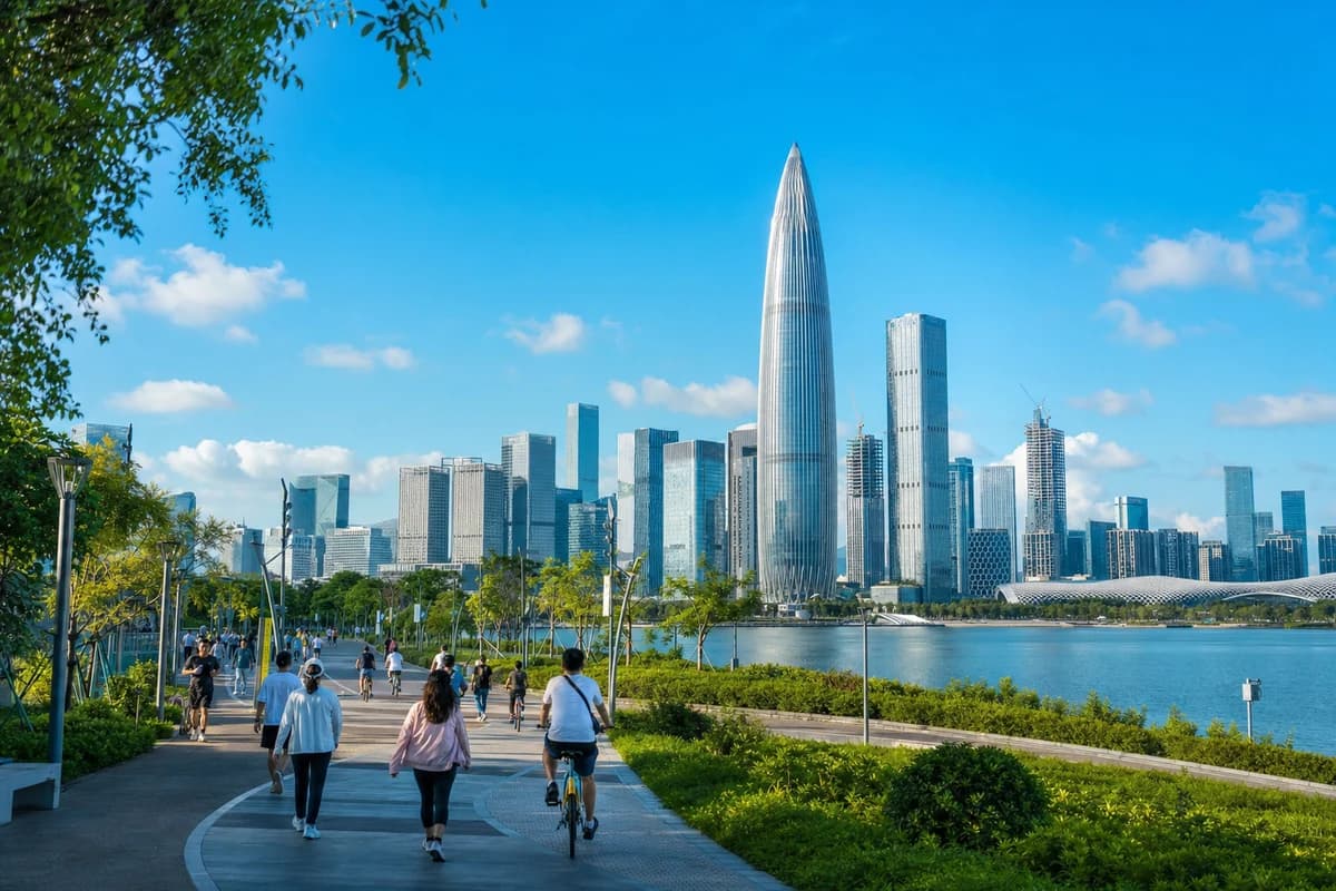 Cyclists and walkers beside Shenzhen Bay with the Nanshan skyline ahead
